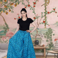 Front view of light blue cotton palazzo pants in palace backdrop