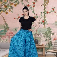 Front view of light blue cotton palazzo pants in palace backdrop