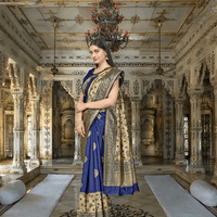 Close-up of golden zari motifs on blue Banarasi silk saree in palace ambience