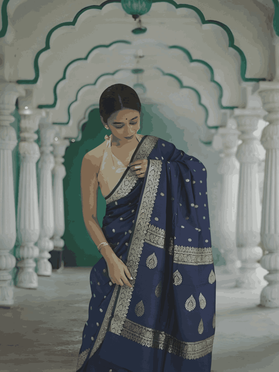 Model draped in full view, navy cotton flowing like calm waters