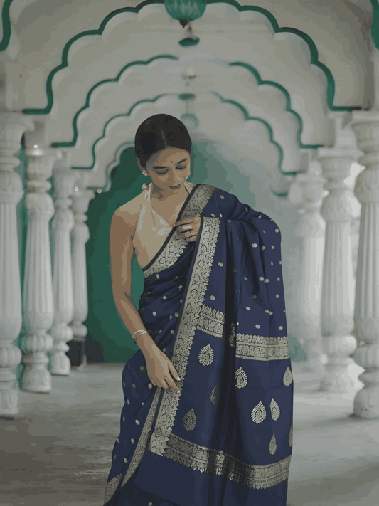 Model draped in full view, navy cotton flowing like calm waters