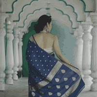 Pallu thrown over shoulder, capturing the fluid print and movement