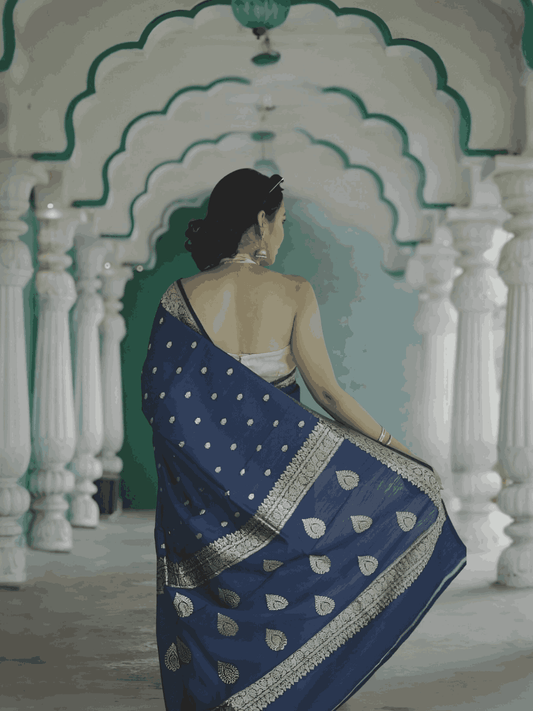 Pallu thrown over shoulder, capturing the fluid print and movement