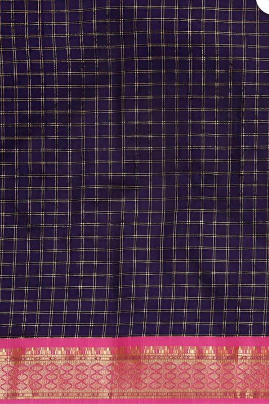 Studio close-up of navy checkered pallu and gold edge glint
