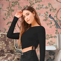 Front view of black round neck full sleeve top for women in palace setting
