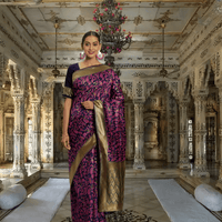 Model in navy and magenta Banarasi silk saree with gold zari in palace room