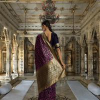Golden diamond pallu of navy pink saree showcased in royal interior