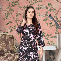  Front view of black kurti with floral print against moody studio wall