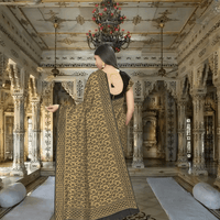 Banarasi silk pallu flowing with golden motifs in luxurious setting