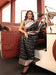 Model standing in a palace doorway wearing the black silk saree