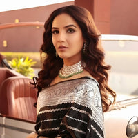 Model turning with flowing pallu and confident gaze