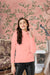 Front view of peach high-neck full sleeve t-shirt in palace background
