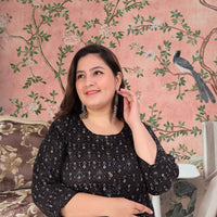 Front view: Black kurti against a soft golden-hour skyline
