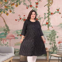 Front view: Black kurti against a soft golden-hour skyline