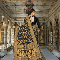 Close-up of intricate gold-yellow floral embroidery on black silk