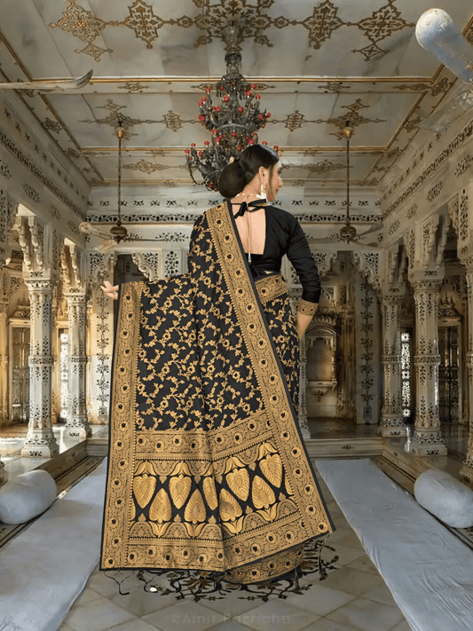 Close-up of intricate gold-yellow floral embroidery on black silk
