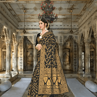 Black Banarasi saree draped elegantly, gold floral patterns glowing in soft light