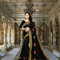 Black net saree against palace arches, silver embroidery glowing like fractured moonlight
