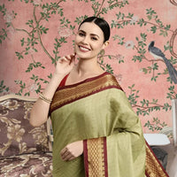 Front view of olive checkered saree in royal indoor setting