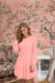 Front view of Peach Serenade dress in soft peach with full sleeves and rounded neckline