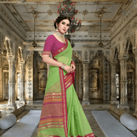 Model in parrot green saree walking through royal arches, border catching morning light