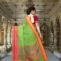 Long shot of saree in motion with pink-golden border trailing behind her steps