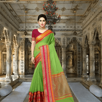 Model walking gracefully through garden, saree catching soft sunlight on green silk
