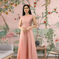 Front view of light peach sleeveless gown in palace setting
