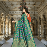 Golden abstract border design on green saree in royal setting