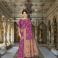 Model wearing purple Banarasi silk saree with gold and floral patterns in palace room