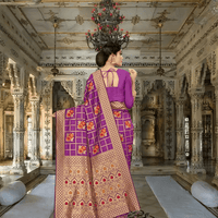 Detailed view of pallu with golden motifs and floral grid design in royal setting