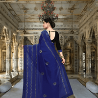 Back drape view of navy saree flowing softly in palace room setting