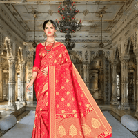 Close-up of golden zari border work on deep red Banarasi silk
