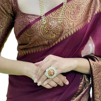 Closeup of fabric showing fine Lichi weave and deep maroon shade – lifestyle background