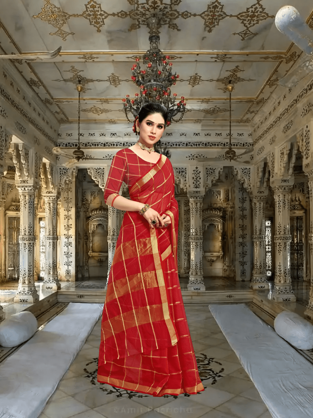 Model in red checkered saree glowing under golden palace lighting
