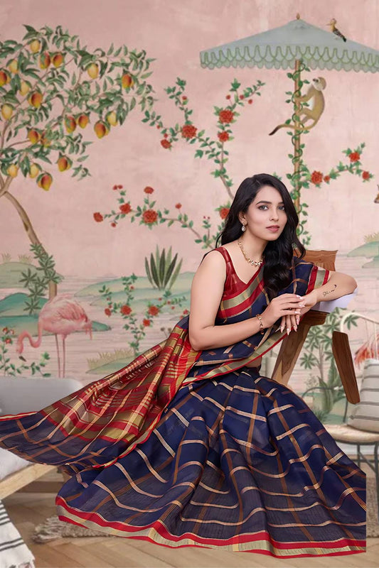  Front view of navy blue checkered saree radiating elegance in palace lighting