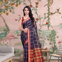 Front view of navy blue checkered saree radiating elegance in palace lighting