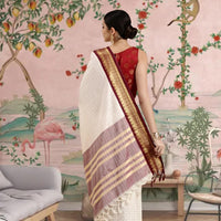 Rear profile showing deep maroon pallu in palace ambience