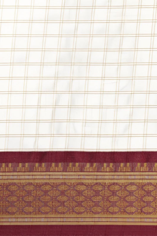 Close-up of pallu showing maroon threadwork and silk blend