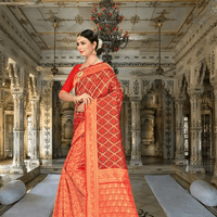 Model in red Banarasi silk saree with gold motifs in palace setting