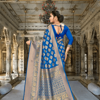 Pallu of wine-blue Banarasi silk saree with gold zari details flowing elegantly