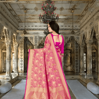 Golden pallu of pink silk saree elegantly flowing in regal backdrop