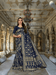 Navy blue silk saree cascading like velvet in a palace corridor, gold thread glowing softly.