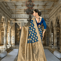 Close-up of golden zari pallu on teal Banarasi saree in a royal ambience