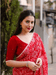 Red abstract georgette saree against modern art backdrop