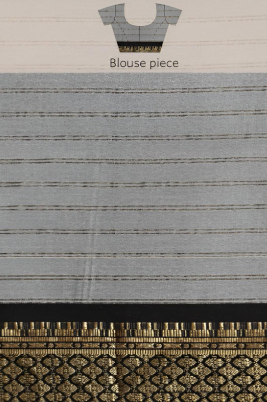 Studio close-up of black-gold bordered blouse detail on soft white saree