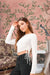 Front view of white round neck full sleeve top in palace room setting