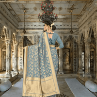 Full pallu view of grey Banarasi saree with gold designs in royal indoor setup