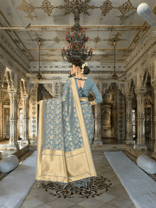 Full pallu view of grey Banarasi saree with gold designs in royal indoor setup