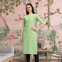 Front view of pista green cotton straight kurti in palace setting